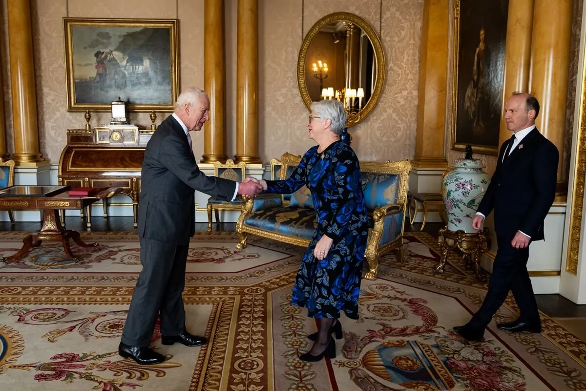 King Charles III shakes hands with Lieutenant Governor of Ontario, The Hon. Edith Dumont and her partner Tony Viscardi during an audience at Buckingham Palace