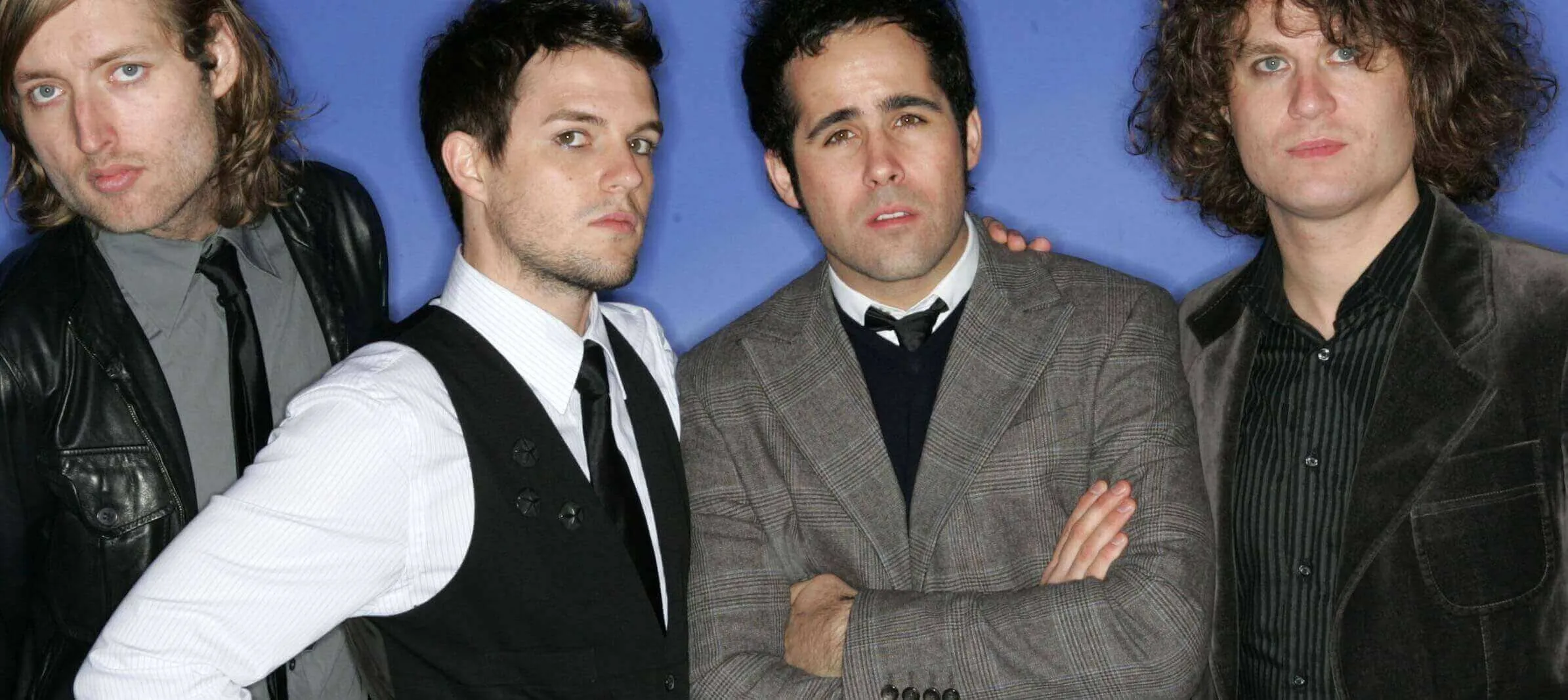 The Killers with a blue backdrop